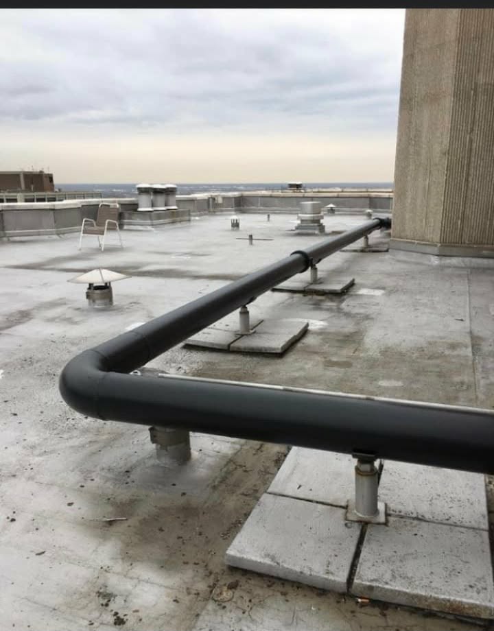 Rooftop pipe coating on a commercial building. — commercial roof coating, pipe coating, rooftop maintenance painting