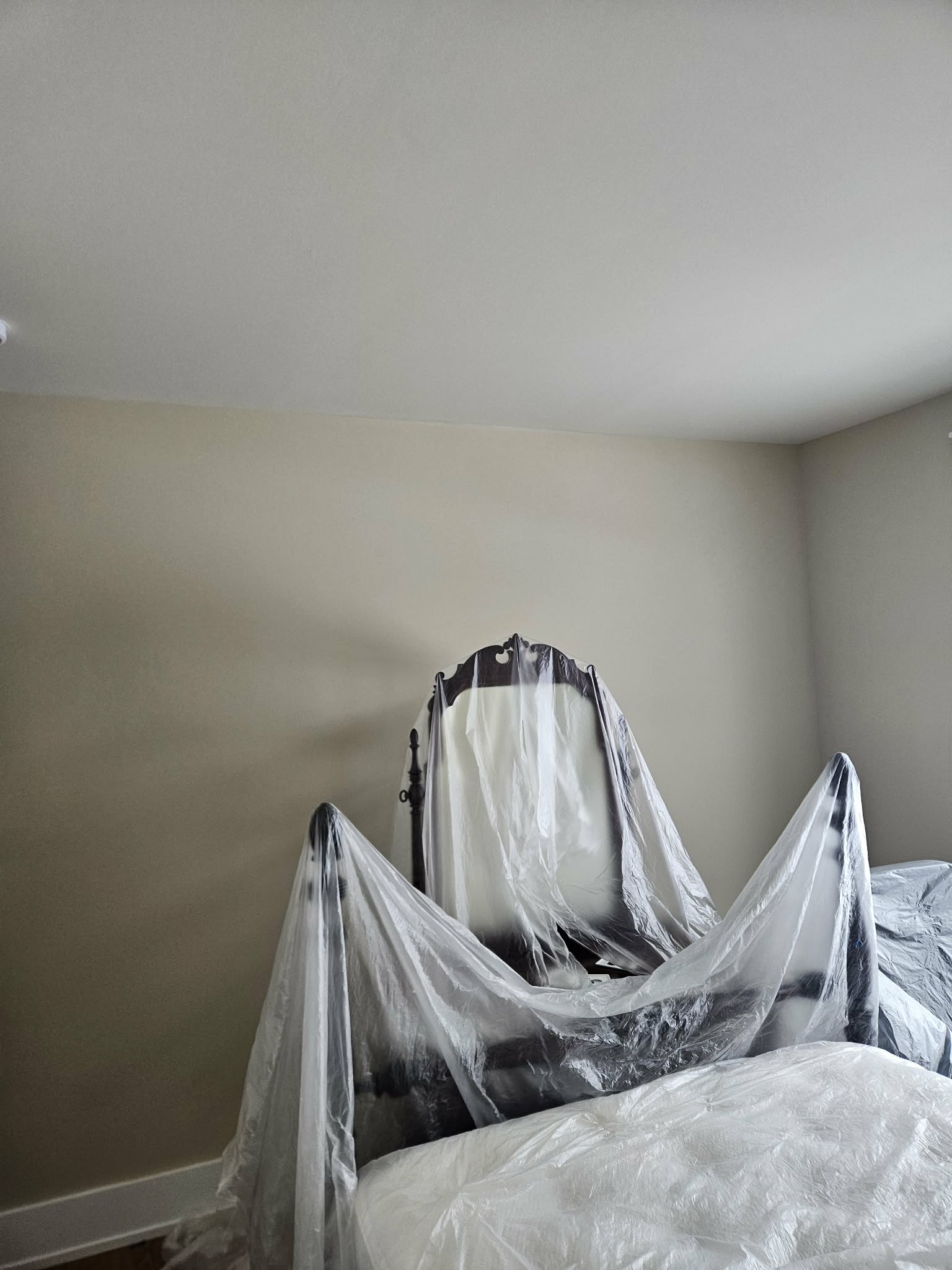 Bedroom furniture carefully covered before painting. — interior painting prep, furniture protection, painting prep
