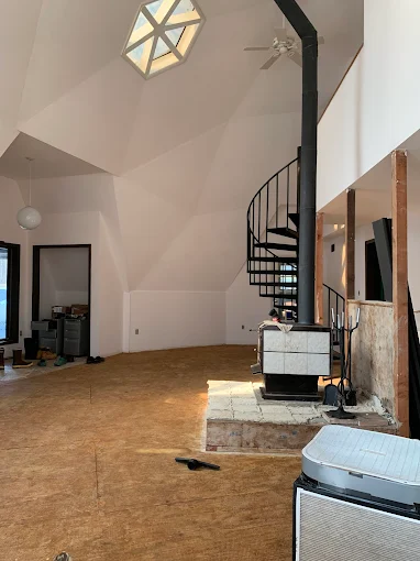 Vaulted great room with smooth cathedral ceilings and fresh neutral walls — interior painting and drywall finishing.