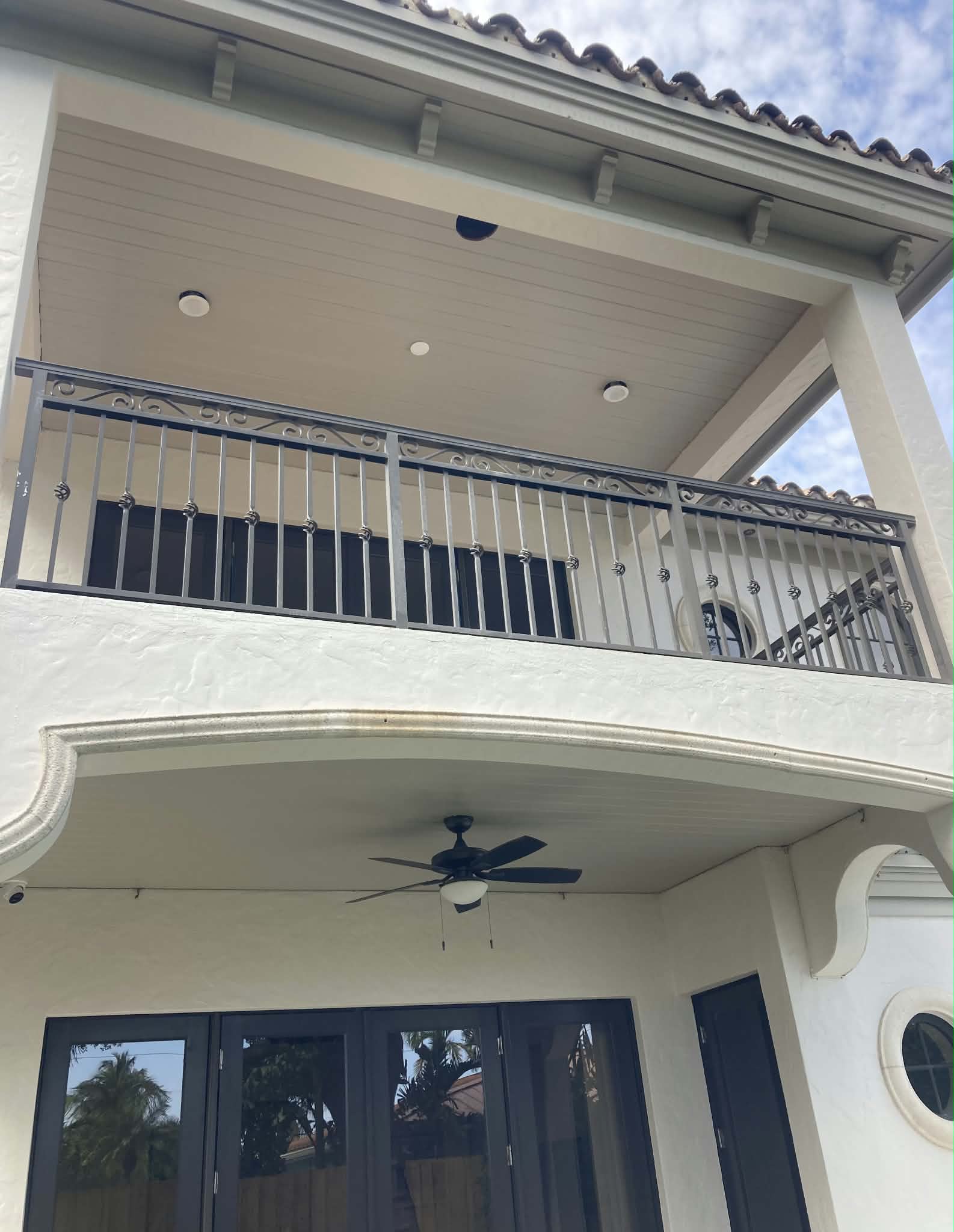 Covered balcony ceiling and soffit repaint with iron railing detail. — exterior painting, soffit painting, balcony ceiling, trim painting