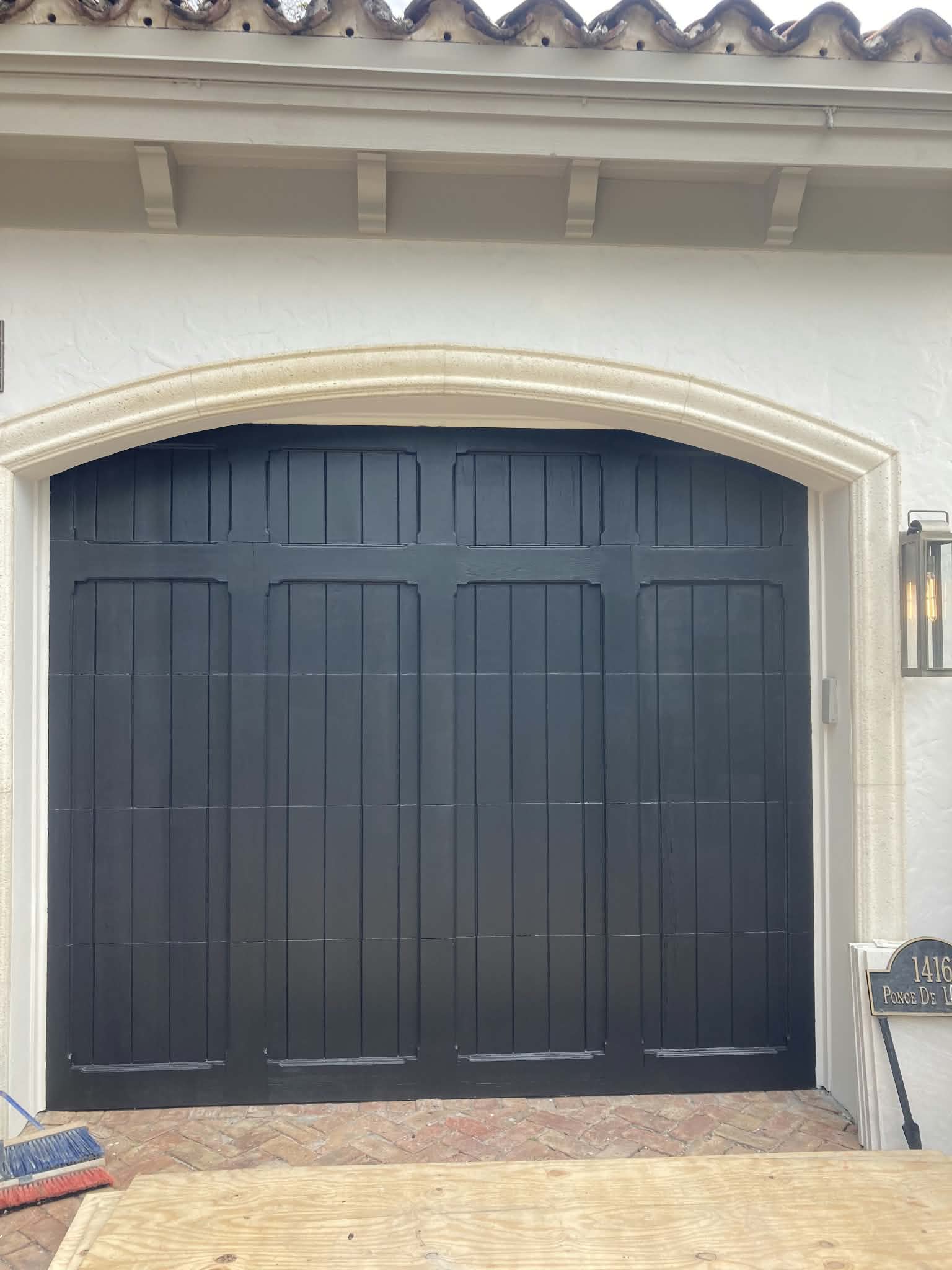 Garage door refinished in a rich charcoal black. — garage door painting, exterior door refinish, charcoal paint