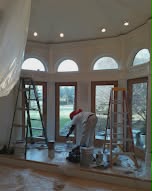 Sunroom with arched windows, wood trim refinished - fine-finish painting and wood trim refinishing.