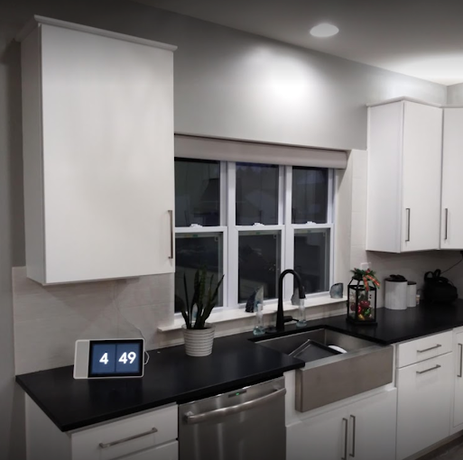 Modern kitchen refresh — smooth grey walls and ceiling with bright white cabinetry and trim. Interior painting.
