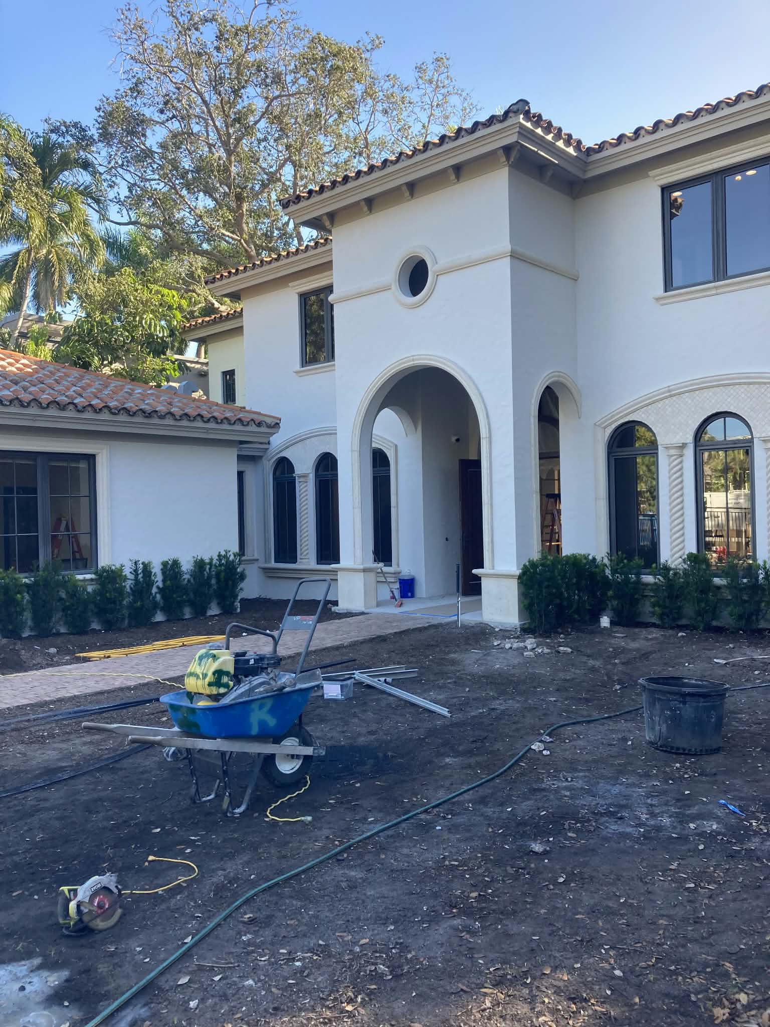 Exterior repaint prep on a large stucco residence. — exterior painting prep, stucco exterior, painting equipment staging