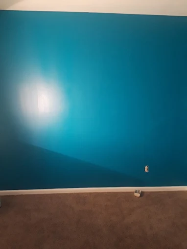 Bold teal accent wall with a flawless smooth finish — interior painting and premium wall preparation.