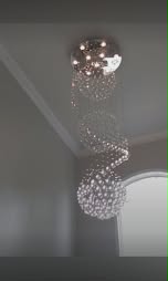 Elegant chandelier in a freshly painted stairwell - interior painting.